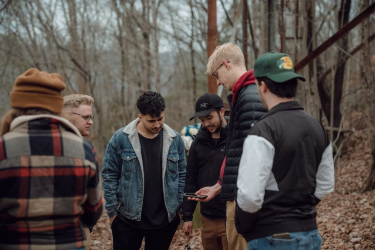 Group of diverse people gathered in a forest, representing community and support